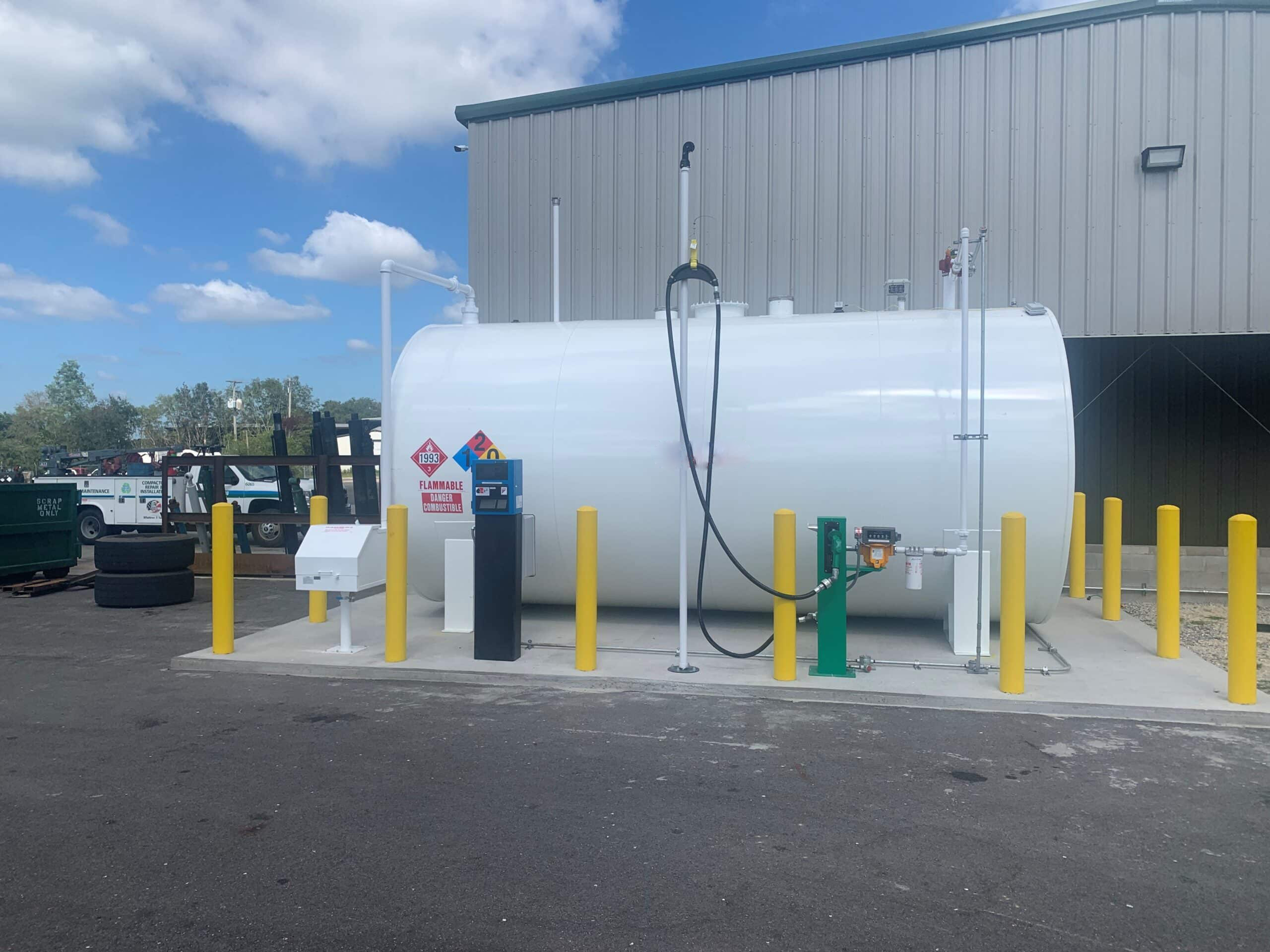 White double-walled fuel tank with safety bollards in a commercial setting