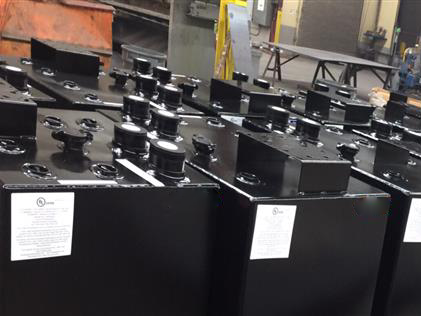 Black steel aboveground storage tanks with multiple valve openings, ideal for automotive and industrial fluid storage applications.