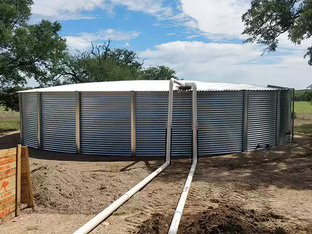 corrugated tank with two pipes running to it