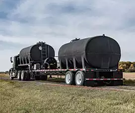 Black Transpor Tanks on flat bed trailer