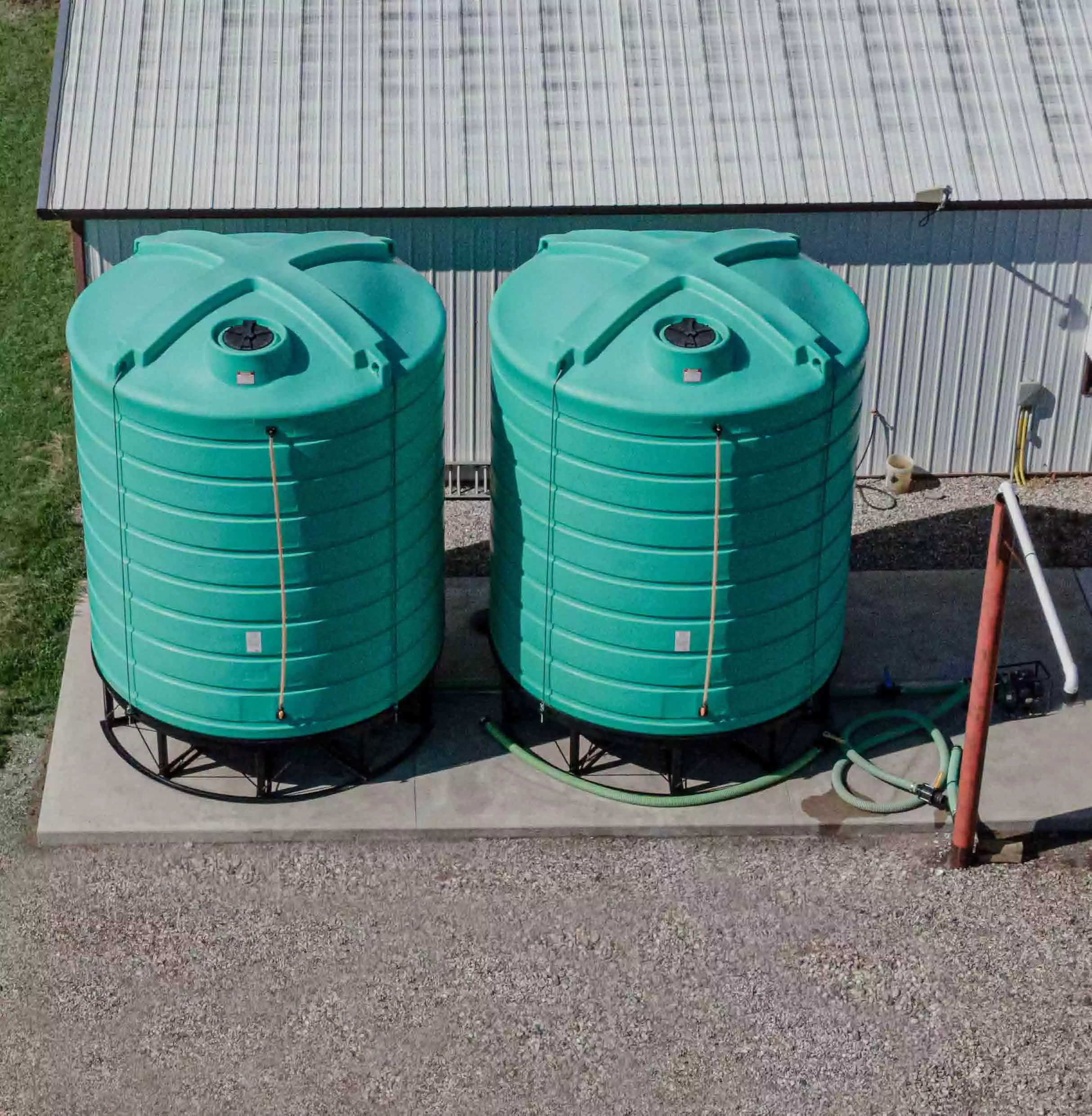 Top view of two blue cone bottom tanks on stands