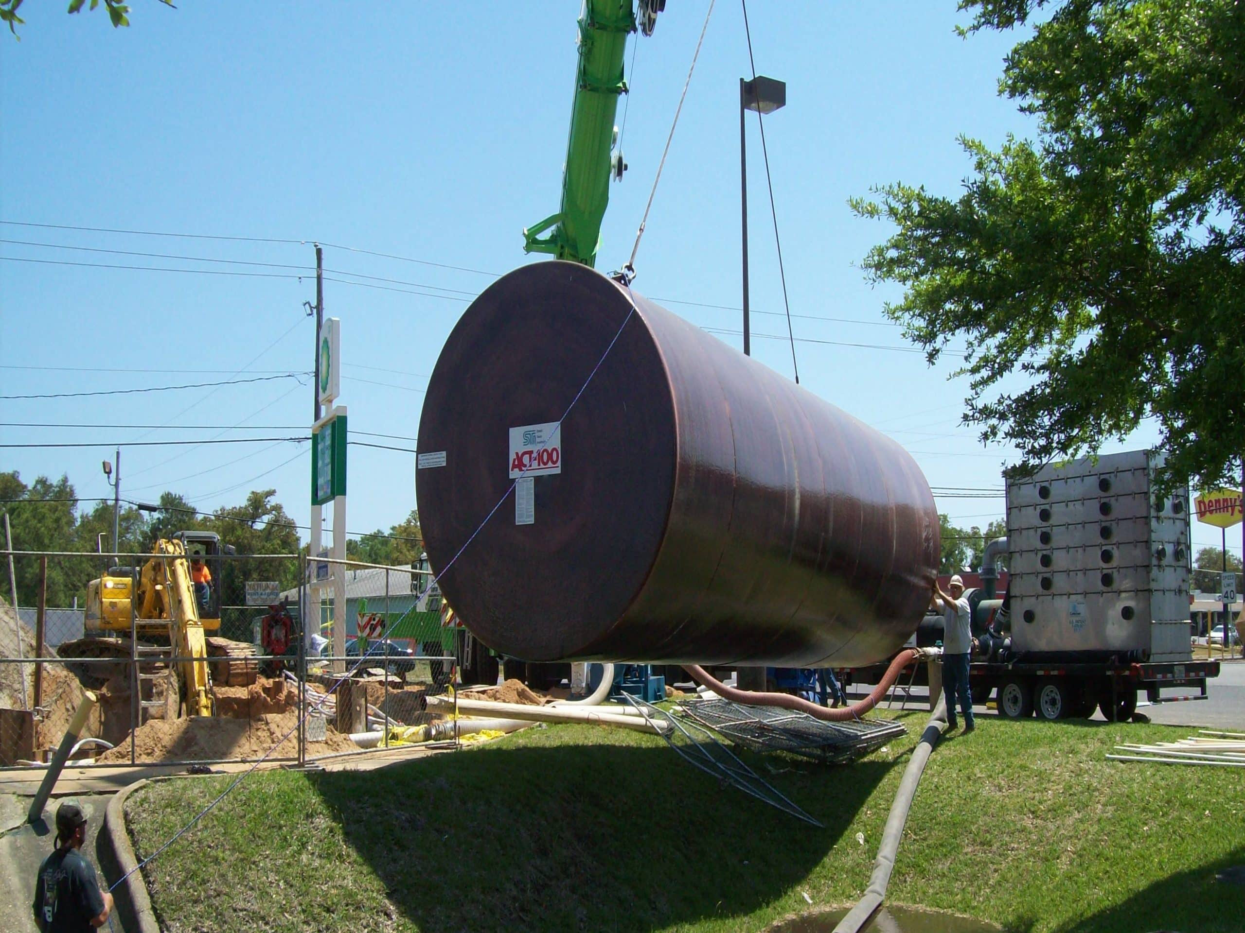 Act100® steel tank being lowered into the ground at a construction site