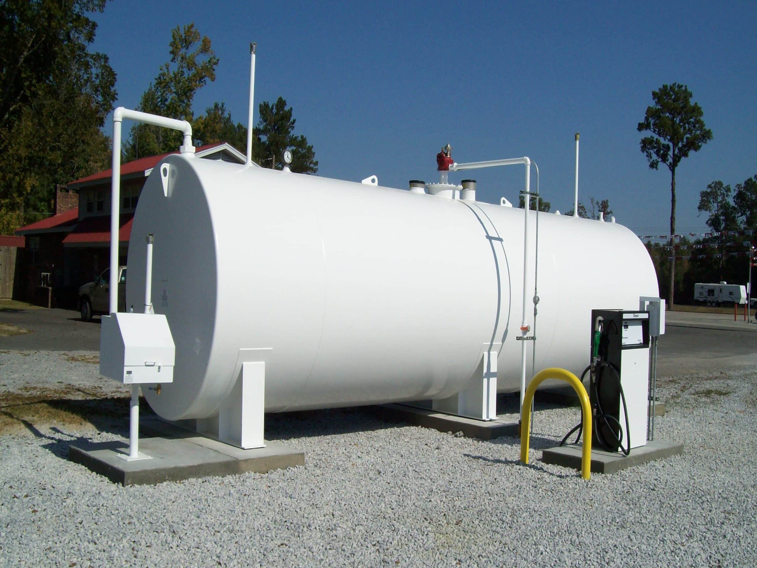 Installation of large double-walled underground storage tanks in a construction site, providing secure and durable fuel storage solutions.